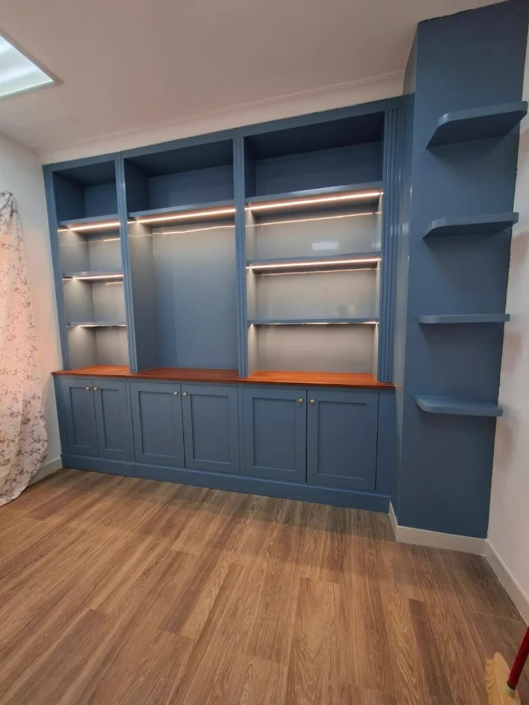 Painted blue cabinetry with wood top and brass knobs — Renovation 786 Dubai