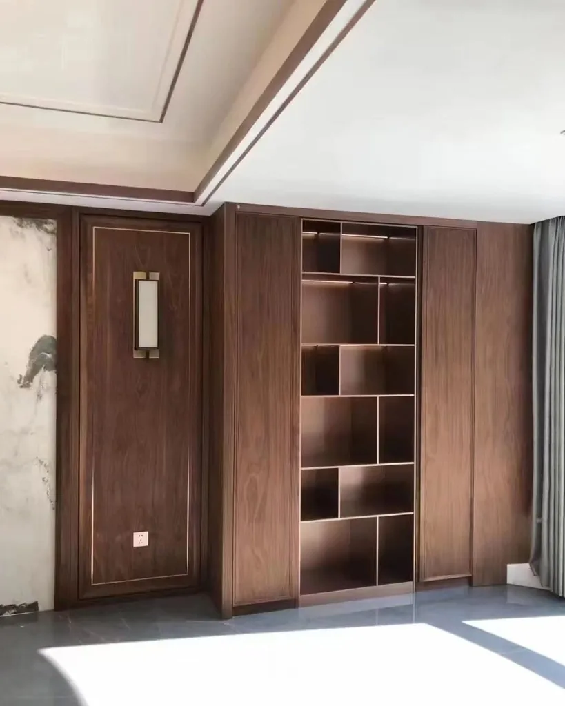 Custom dark wood joinery with illuminated shelving — Renovation 786 Dubai