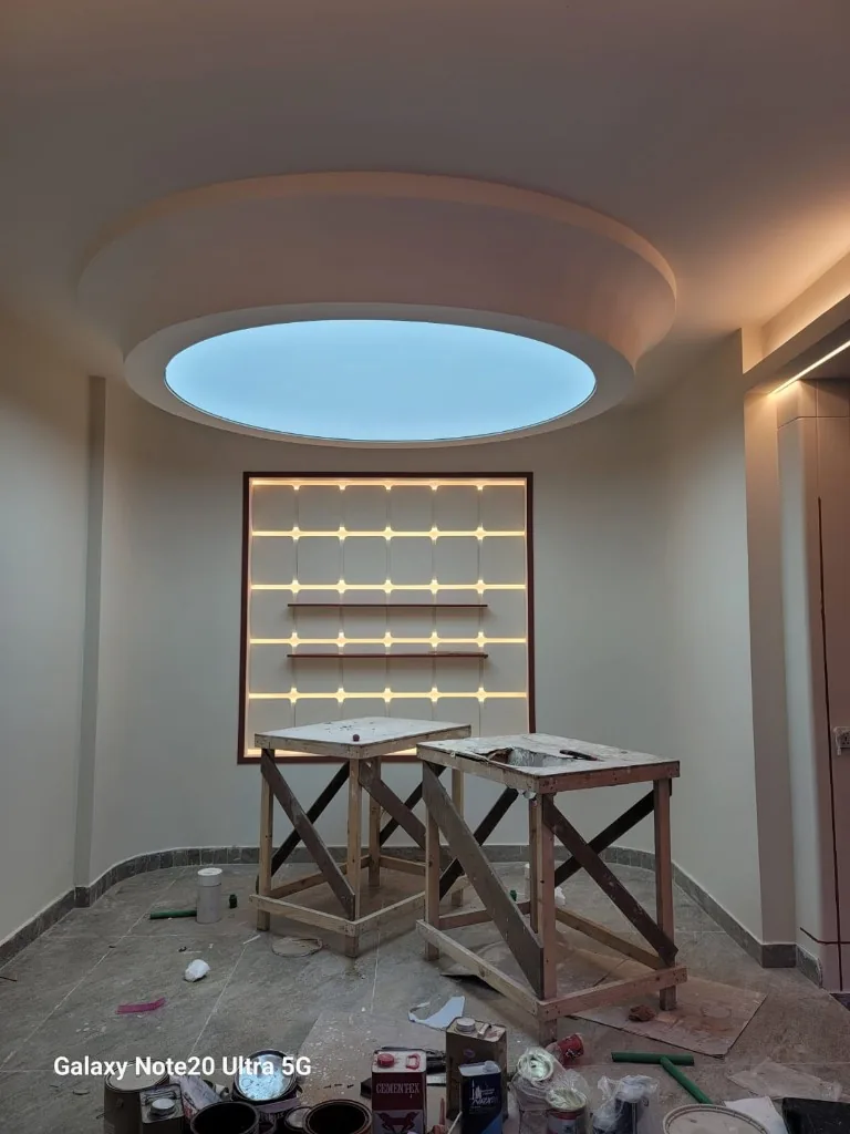 Circular cove ceiling light with backlit feature wall niches — Renovation 786 Dubai