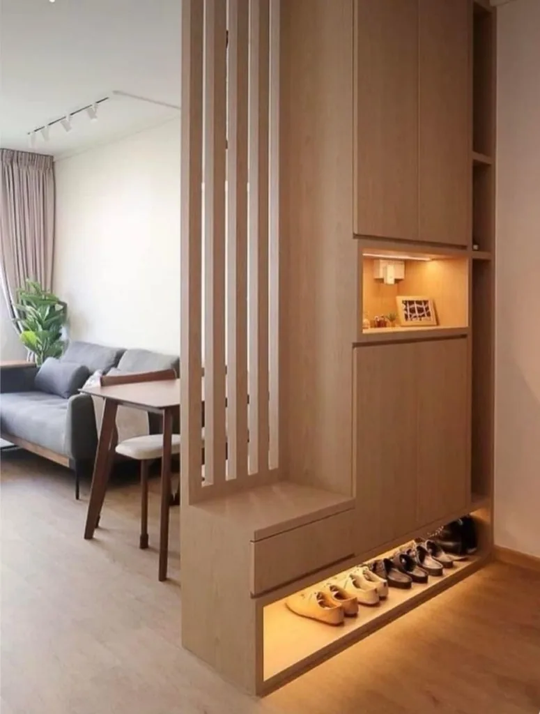 Custom wood joinery partition with illuminated niches and cabinetry — Renovation 786 Dubai